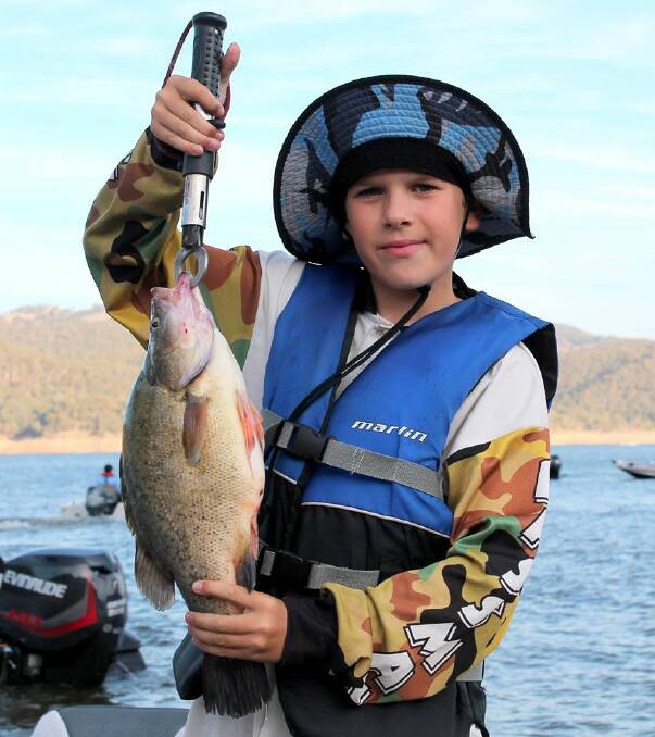 A keen young fisherman with one of the bigger yellows caught on the day.