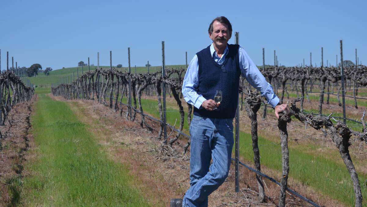 Greg Gallagher at his Gallagher Wines vineyard, with the 2014 Tradies Moving Feast Festival wine glass. Photo: Jessica Cole. 