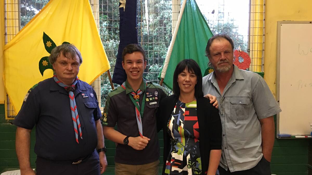 Braeden Adams with his parents Kylie and John and Scout Leader Don McCann.