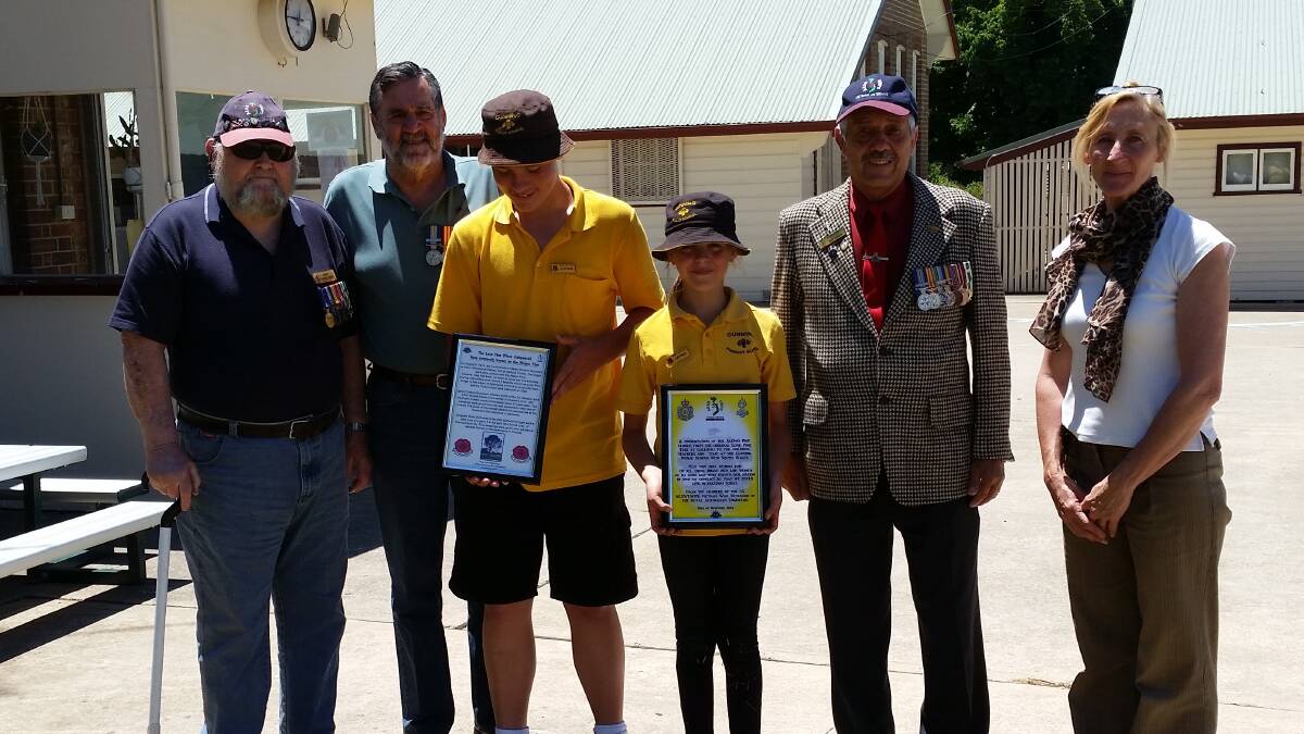 Bert Hagel (OAM), Ray Seymour, Gunning Public School Captains Bailey Lanham and Lilybell Brett holding 'Lone Pine' plaques,  John 'Speedie' Sahariv and the school’s Acting Principal Janelle Lawrence at the 'Lone Pine' planting.
