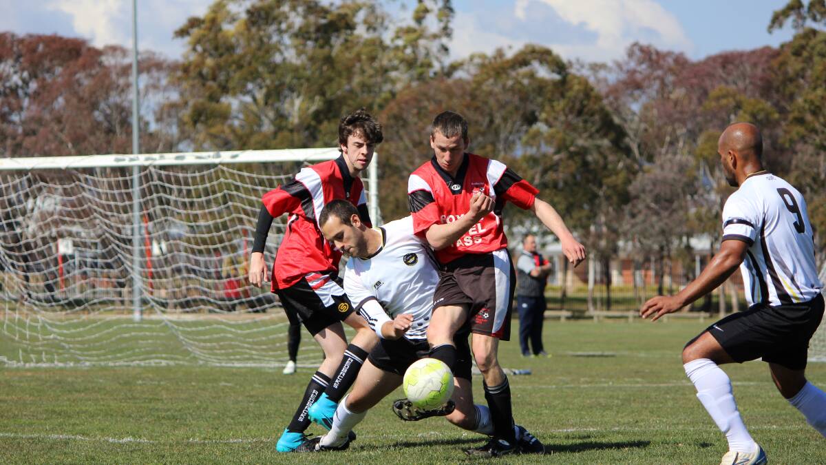 Redback Richard Alley clears the ball in the division six major semi-final against Gungahlin United on Saturday. Photo: Amy Alley.
