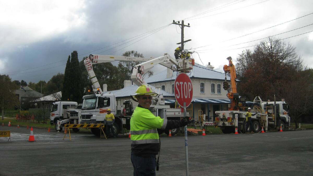 John Henshaw helped direct traffic as the major work proceeded in replacing a vital power pole by Essential Energy on the corner of Yass and Warrataw Street on May 20. A district wide power outage for six hours was experienced.
