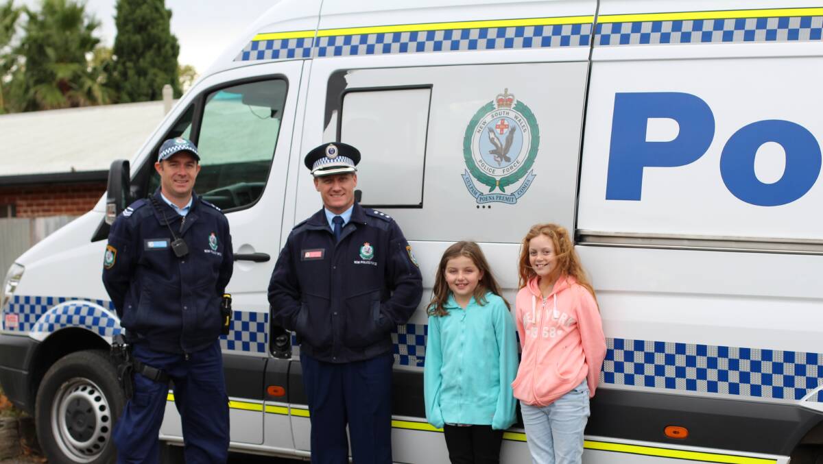 Senior Constable Dan Condon, Detective Inspector Chad Gillies, with interested locals Ali Baker and Lillian Dominick.