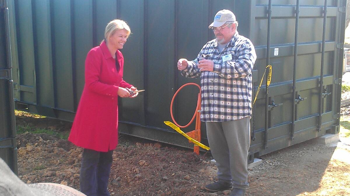 Katrina Hodgkinson cutting the ribbon with the president of the Yass Men's Shed, David Staines, looking on. Photo: Supplied.