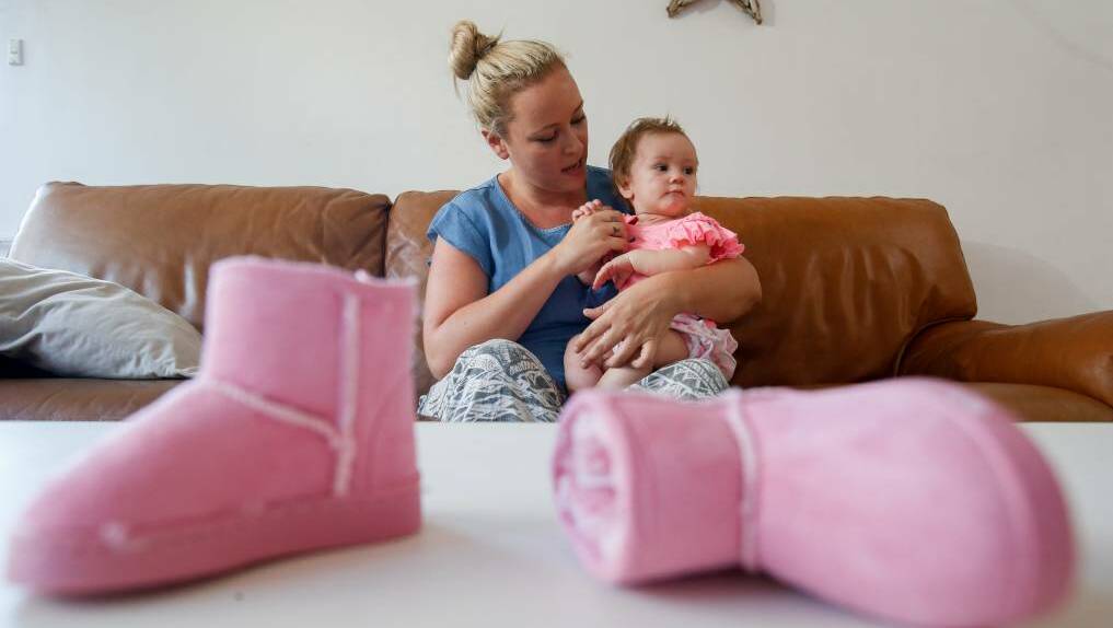 Suzi Meyer and year-old Raven, pictured with a larger set of ugg boots bought for Raven's sister, have been visited by a Target representative. Picture: Adam McLean