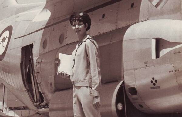 The young RAAF nurse in front of a Hercules.