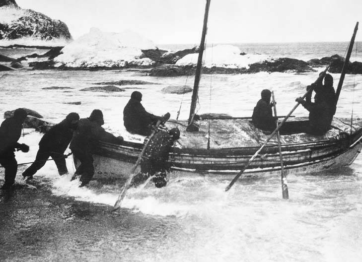 Frank Hurley's photograph of Shackleton's rowing boat, the James Caird, being launched from Elephant Island in 1916.