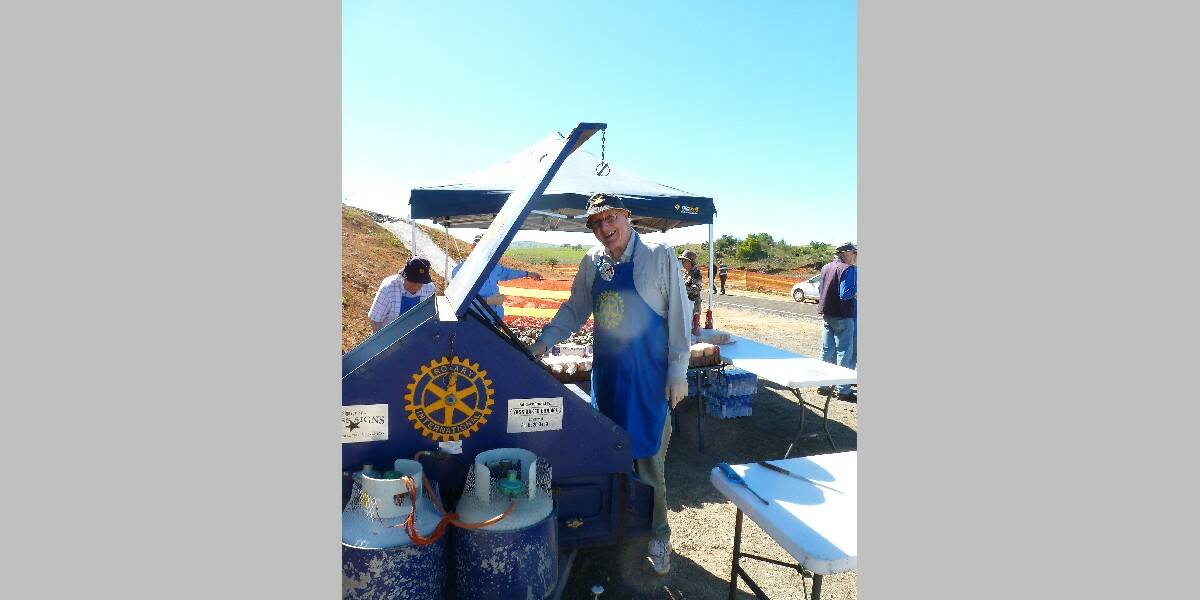 Alfred McCarthy of Rotary helps on the barbecue. Photo: Tony MacQuillan.