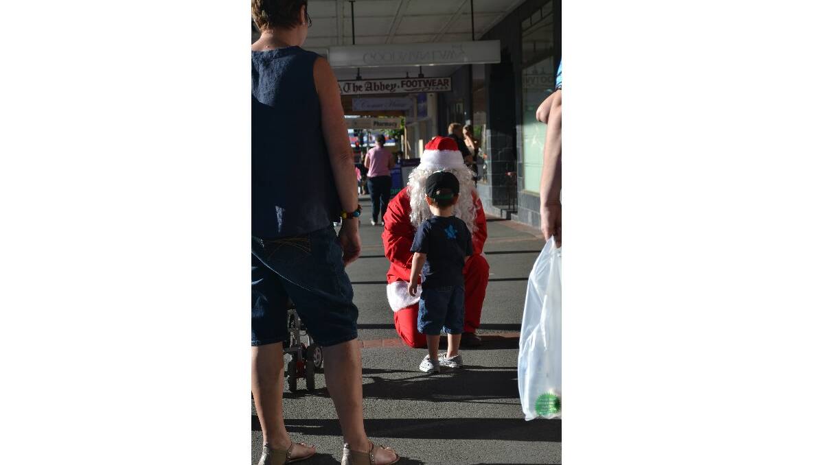 Santa stops for  chat with a young 'un.