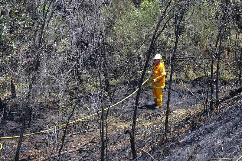 Fire fighters work to put out a fire at Manton, north east of Yass, on Wednesday.