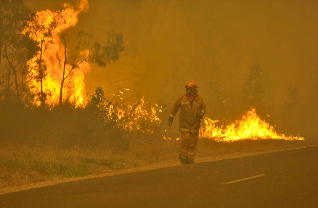 Firefighters prepare to defend the Glenmaggie Caravan Park. Photo: Michael Clayton-Jones