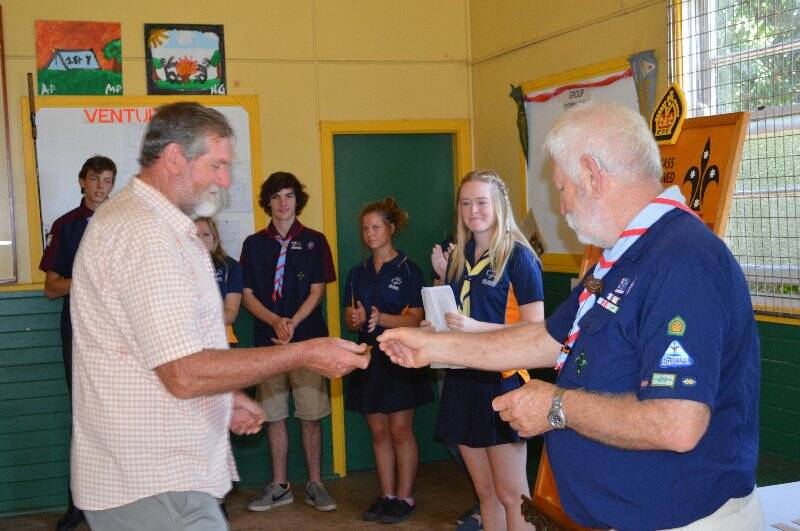 John Pearsall collects for Colleen Pearsall who is presented with a plaque with her name on it to go on the Queens Scout honour role for the 1st Yass Combined Unit.
