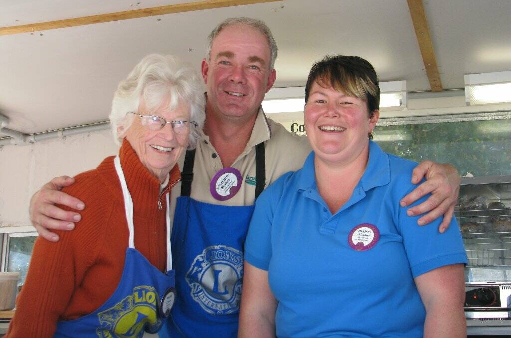 Pam Lees with other members of the Lions Club Cameron Mackay and Mel Primmer working hard on one of many barbecues.