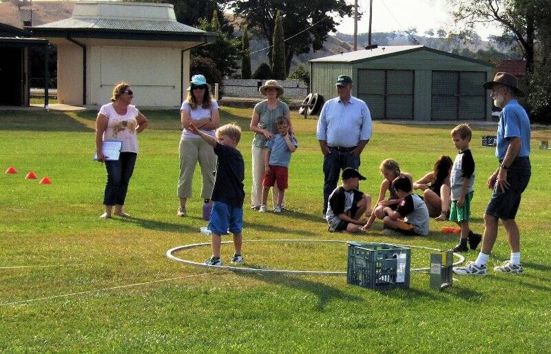 A group of young athletes and parents practising discus with instructor Mike Poulton.