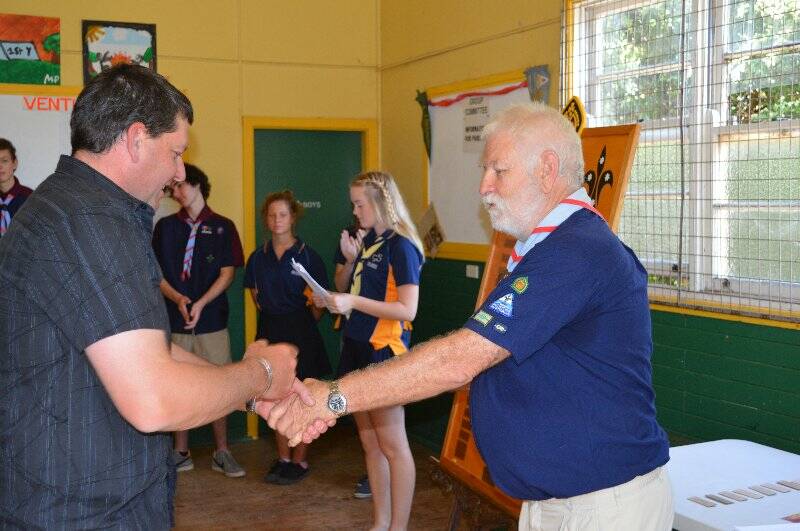 Anthony Palko is presented with a plaque with his name on it to go on the Queens Scout honour role for the 1st Yass Combined Unit.