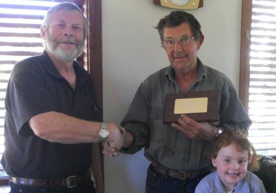 John Boddington presents Graham Baines with a plaque to commemorate his years of service.