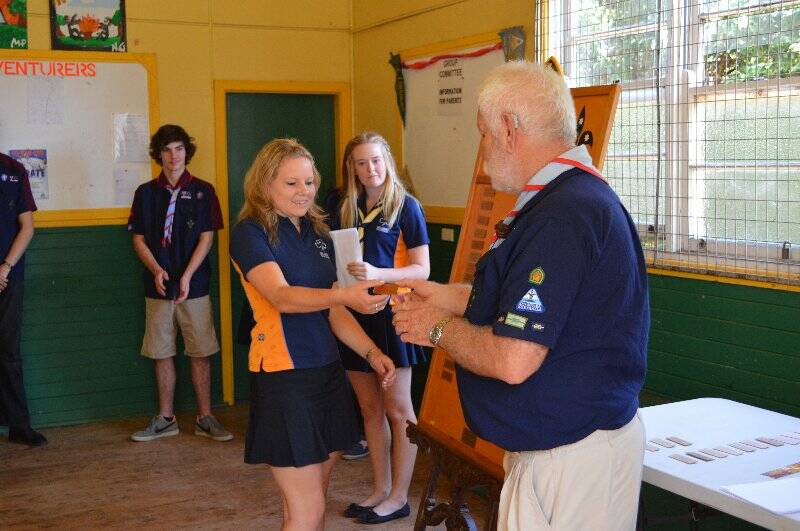 Sarah parker collects on behalf of Stephanie Hogan who is presented with a plaque with her name on it to go on the Queens Scout honour role for the 1st Yass Combined Unit.