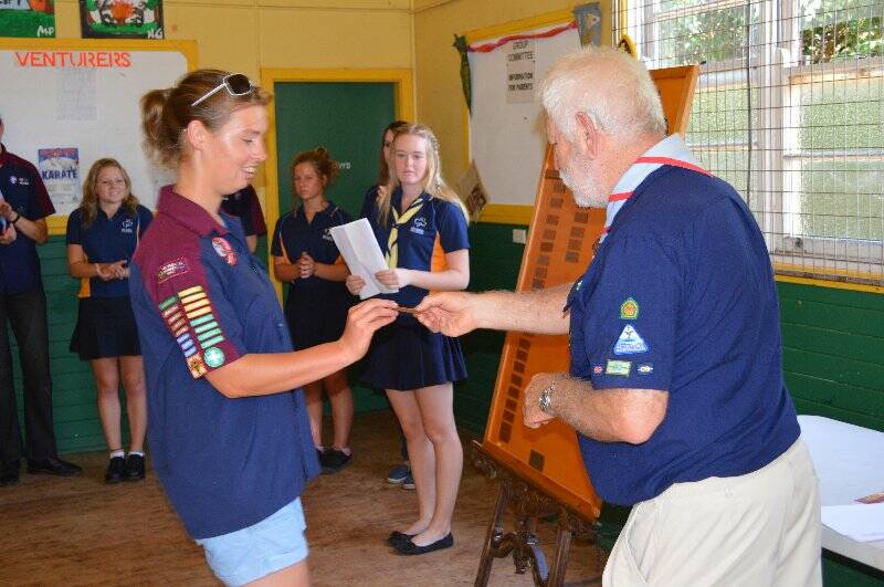 Savannah McGuirk is presented with a plaque with her name on it to go on the Queens Scout honour role for the 1st Yass Combined Unit.