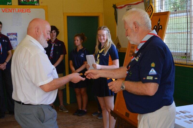 John Wicks is presented with a plaque with his name on it to go on the Queens Scout honour role for the 1st Yass Combined Unit.