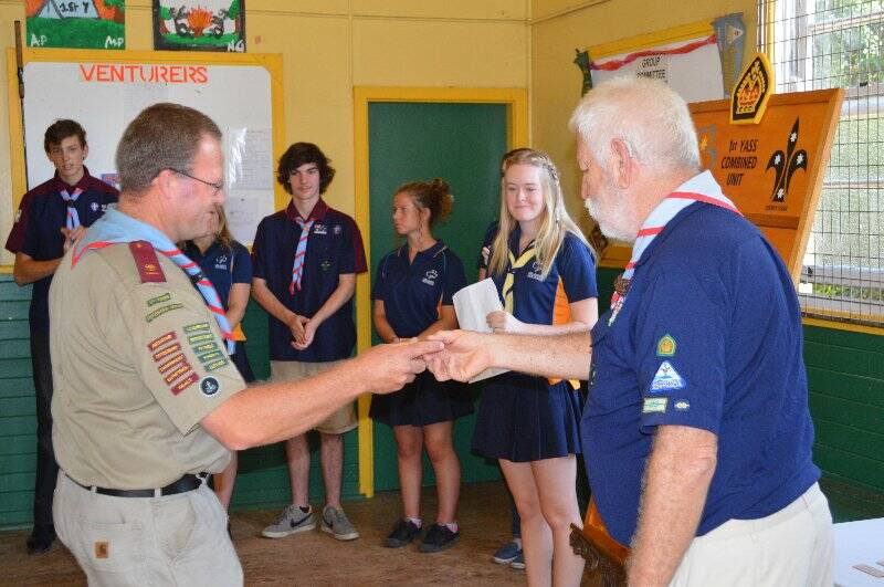 Paul Holmes is presented with a plaque with his name on it to go on the Queens Scout honour role for the 1st Yass Combined Unit.