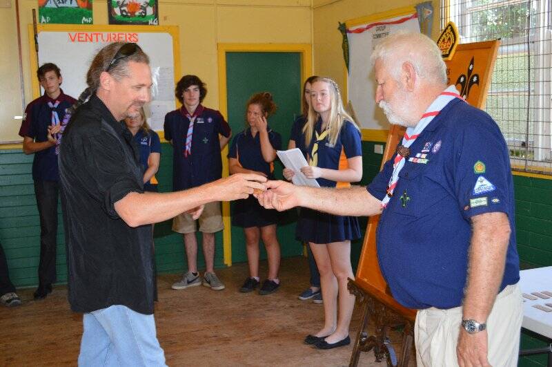 Ken McNally is presented with a plaque with his name on it to go on the Queens Scout honour role for the 1st Yass Combined Unit.