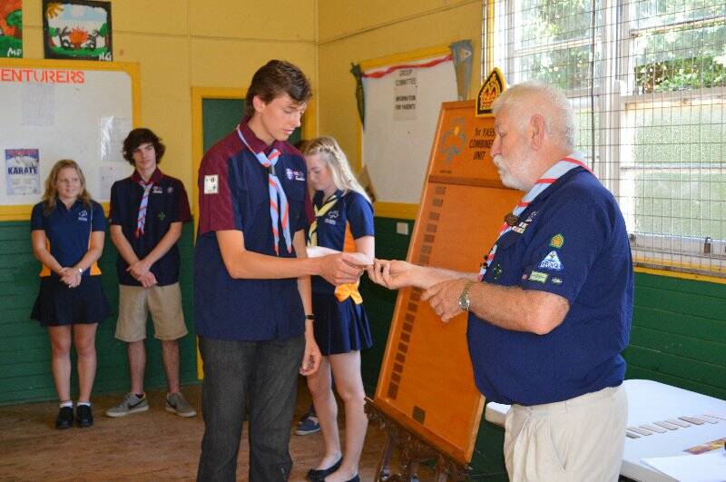Adam Bates collects for Kathryn Hogan who is presented with a plaque with her name on it to go on the Queens Scout honour role for the 1st Yass Combined Unit.