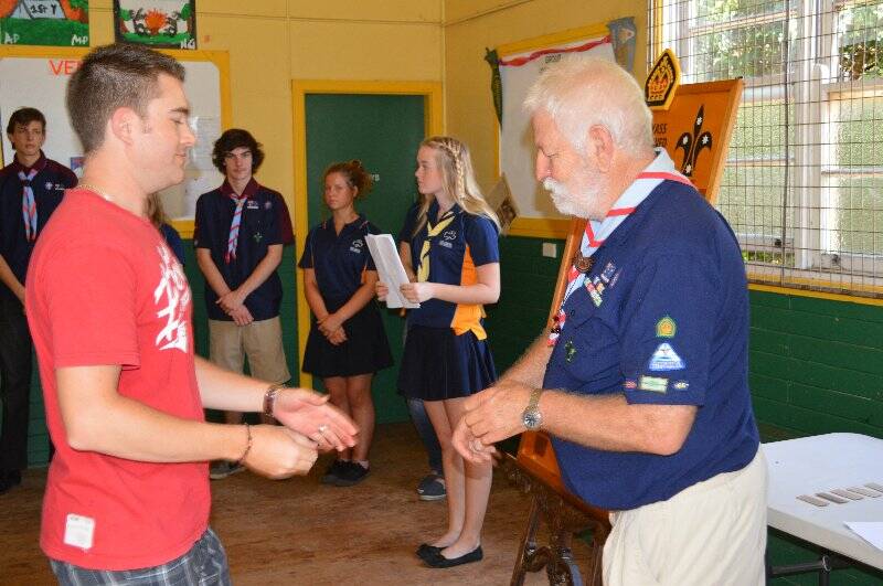 Leon Gold is presented with a plaque with his name on it to go on the Queens Scout honour role for the 1st Yass Combined Unit.