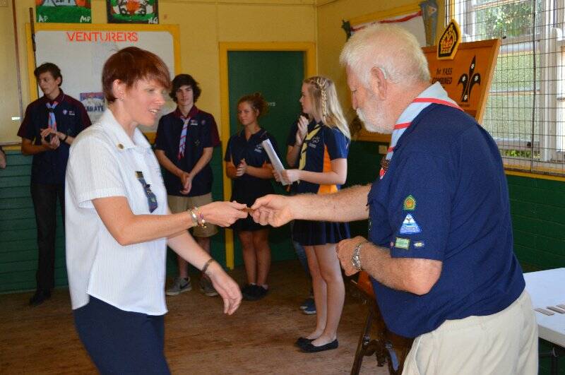 Chrissie Erickson is presented with a plaque with her name on it to go on the Queens Scout honour role for the 1st Yass Combined Unit.