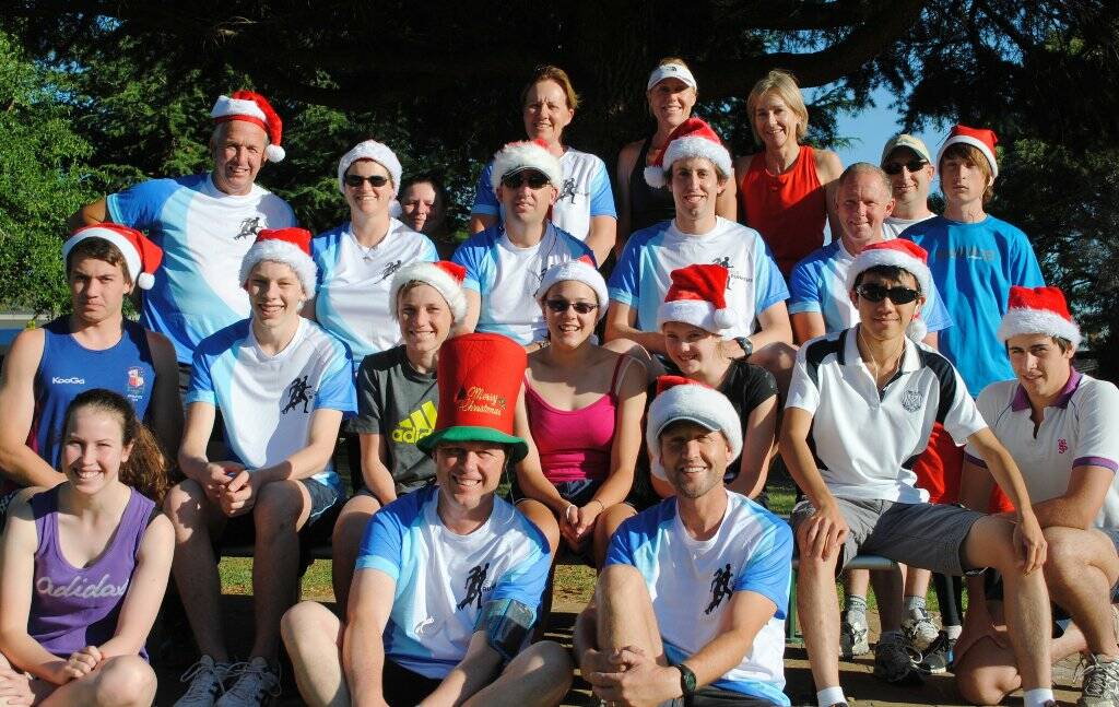 Members of the Yass Runners, some in their new shirts, bring in Christmas on Monday. Some wore the Santa hats running for eight kilometres.   