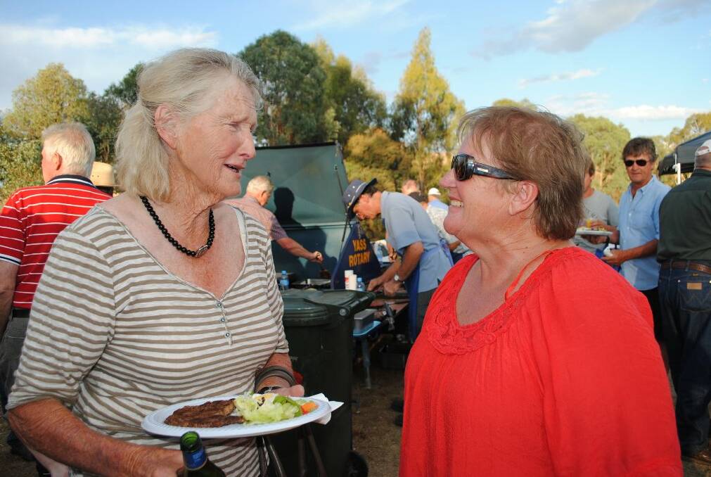 Caroline Spittle and Esme Armour share stories and laughs, as they reconnected during the Bookham barbecue on Monday evening.