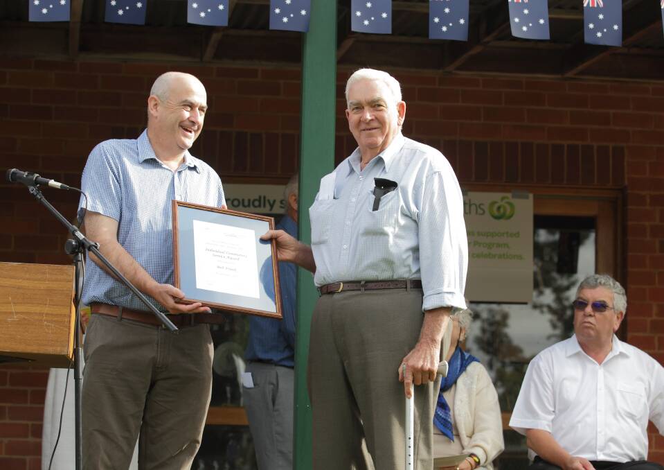 Councillor Michael McManus presents Bob Frank an award for Community Service.