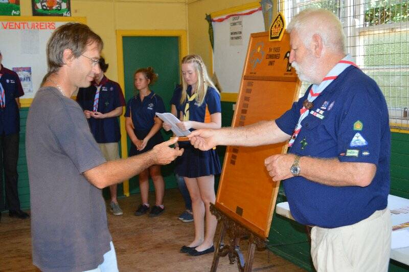 Graham Hjort is presented with a plaque with his name on it to go on the Queens Scout honour role for the 1st Yass Combined Unit.