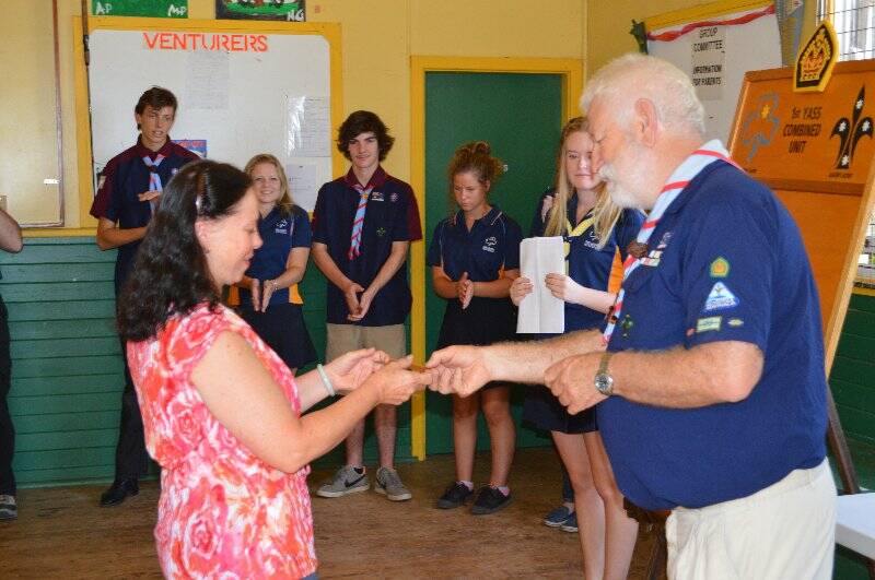 Christine Philipse is presented with a plaque with her name on it to go on the Queens Scout honour role for the 1st Yass Combined Unit.