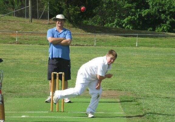 Will Goode bowling for the Sixes in the Weston Shield. Umpiring is Iain Kemp.