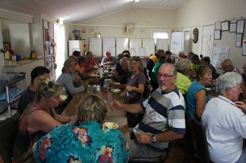 BlazeAid volunteers tuck into dinner at the end of a hard days work. 
