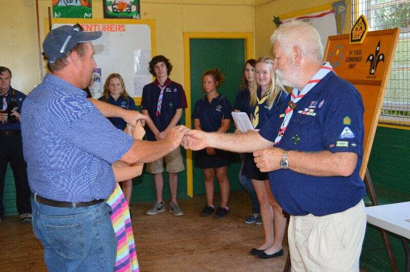 Peter Makin is presented with a plaque with his name on it to go on the Queens Scout honour role for the 1st Yass Combined Unit. All photos: David White.