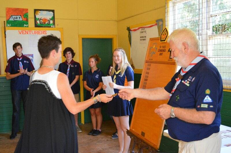 Roseann Slattery is presented with a plaque with her name on it to go on the Queens Scout honour role for the 1st Yass Combined Unit.