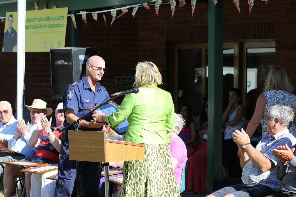 Mayor Rowena Abbey presents Michael Gray, RFS Group One captain, an award which served as thanks to all the volunteers for their work recently. Photo: Tiffany Grange.