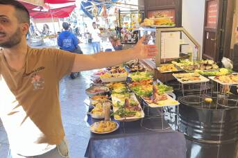 Sardines, smoke and street treats: a feast for the senses in this fabled Italian market
