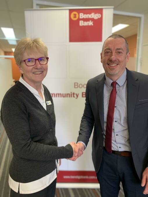 New role: Sue Corcoran, chair of Boorowa Community Bank® Branch of Bendigo Bank, welcoming new business development manager Darren Manton. Photo: Supplied.