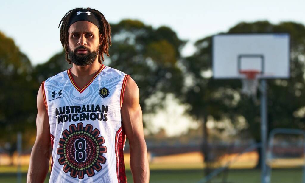 A classic with deep roots: Patty Mills models the new Australian Indigenous Basketball All Stars jerseys designed by Harry Pitt. Picture: Travis Hayto
