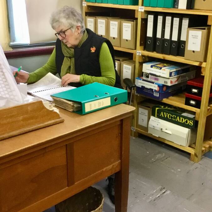 HARD AT WORK: Wilma researching buildings and locations to compile an index. Photo: Susan O'Leary.