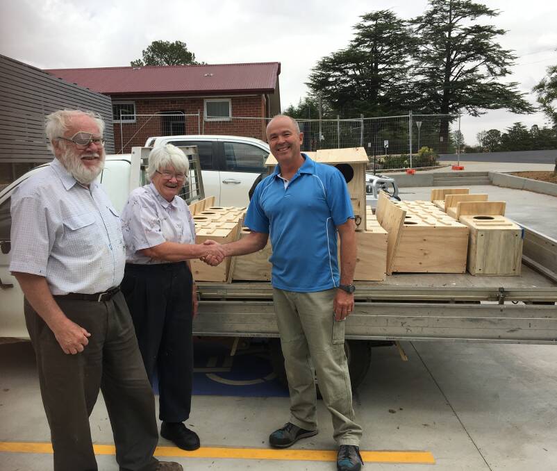 THANKS, POSSUM: Kevin and Jane Baker from Wildcare gratefully receive 25 possum boxes from Yass HIgh School teacher Ralf Hansson.