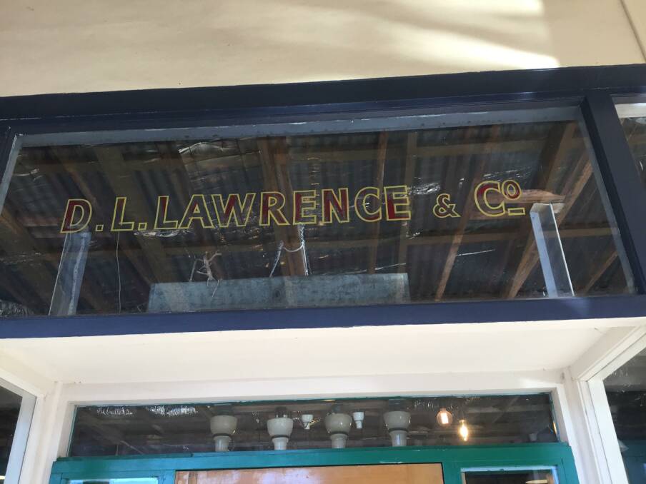 STILL THERE: Lawrence business sign above the door of current Trader & Co. Meehan Street. Photo: Susan OLeary.