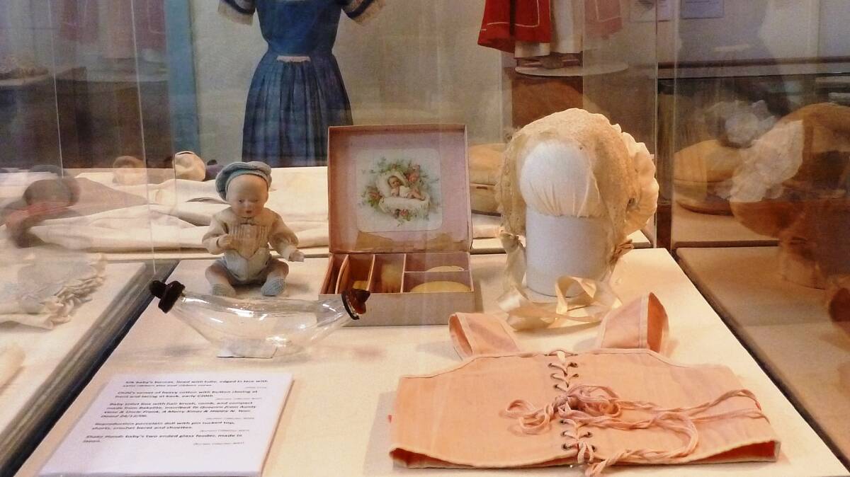 CHILD'S CORSET: One of the more unusual items is an early twentieth century child's corset, seen here with an antique two-ended baby feeder. Photo: Tony MacQuillan