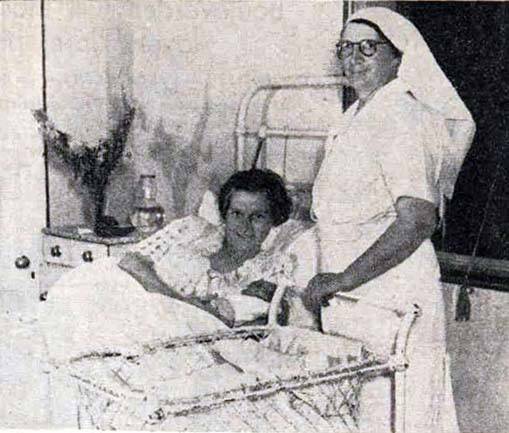 RESCUED: Mrs Ray Dunn with infant son Alan David, resting in the care of Sister Ann Stadtmiller at Devonia private hospital, after Alan's premature birth during the Bookham bush fire. Photo: Trove, Australian Women's Weekly, February 10, 1940.