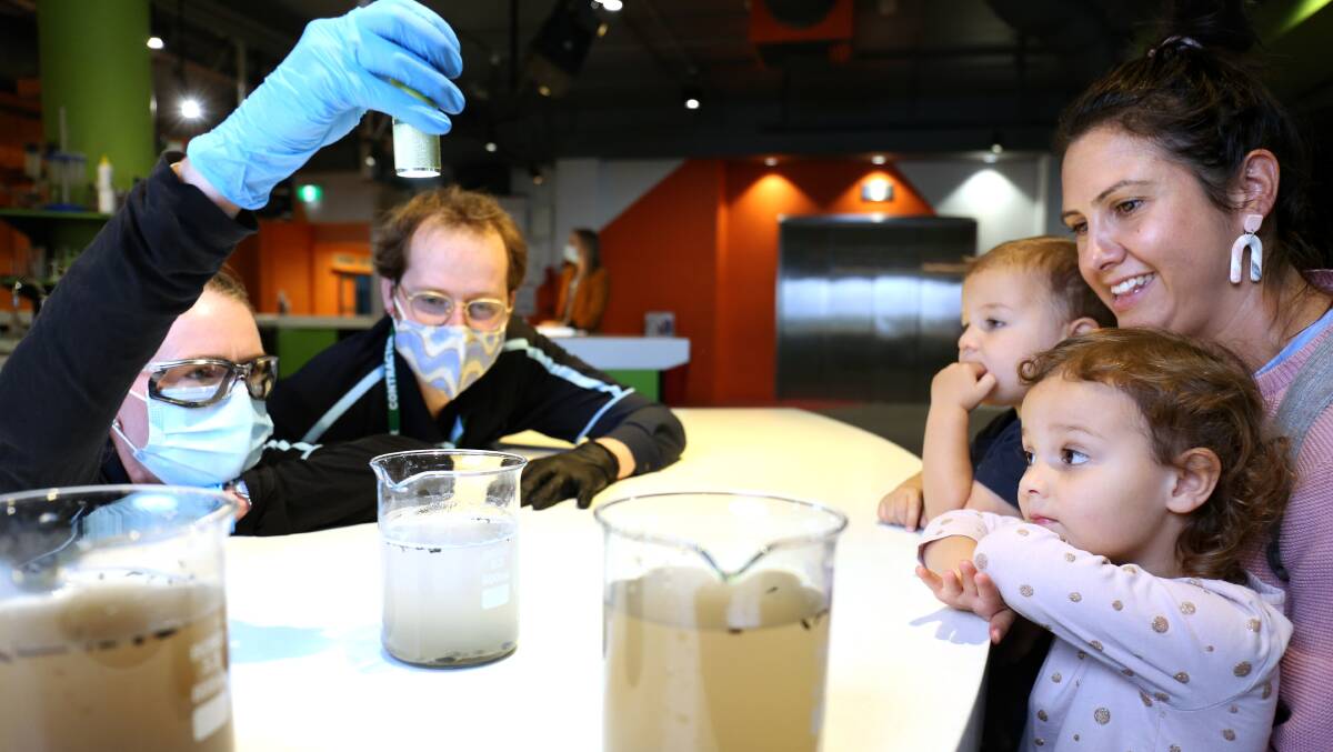 Icon Water's Peter Grimmett and Leah Speight give a water cleaning demonstration to Kate Woodcroft and her children Elsie, 3 and Coen, 2, for the Free the Poo launch at Questacon. Picture: James Croucher