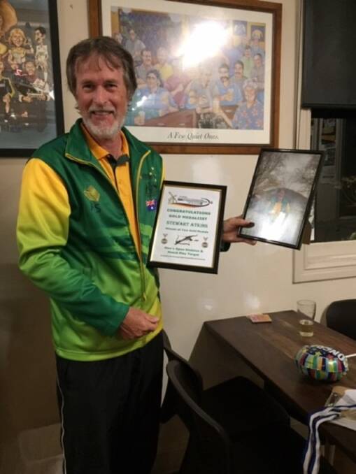 Awarded: Stuart Atkins is all smiles during the surprise presentation ceremony at the Bowning Hotel last Friday, which celebrated his achievements at the 2019 Crossbow World Championships. Photo: Supplied.