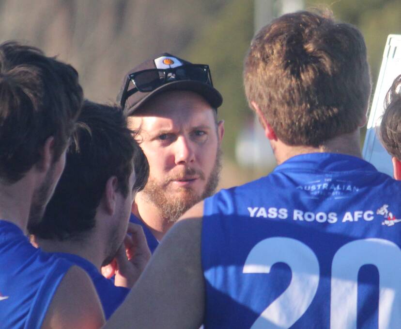 Team talk: Coach Adam Curtois addresses the Yass Roos at the end of the third quarter. Photo: Zac Lowe.