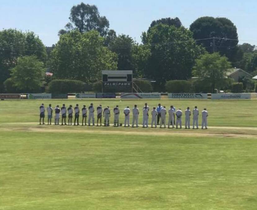 Take a minute: The teams observe a moment of silence at 11.00am to pay their respects to Remembrance Day. Photo: Yass District Cricket Association.